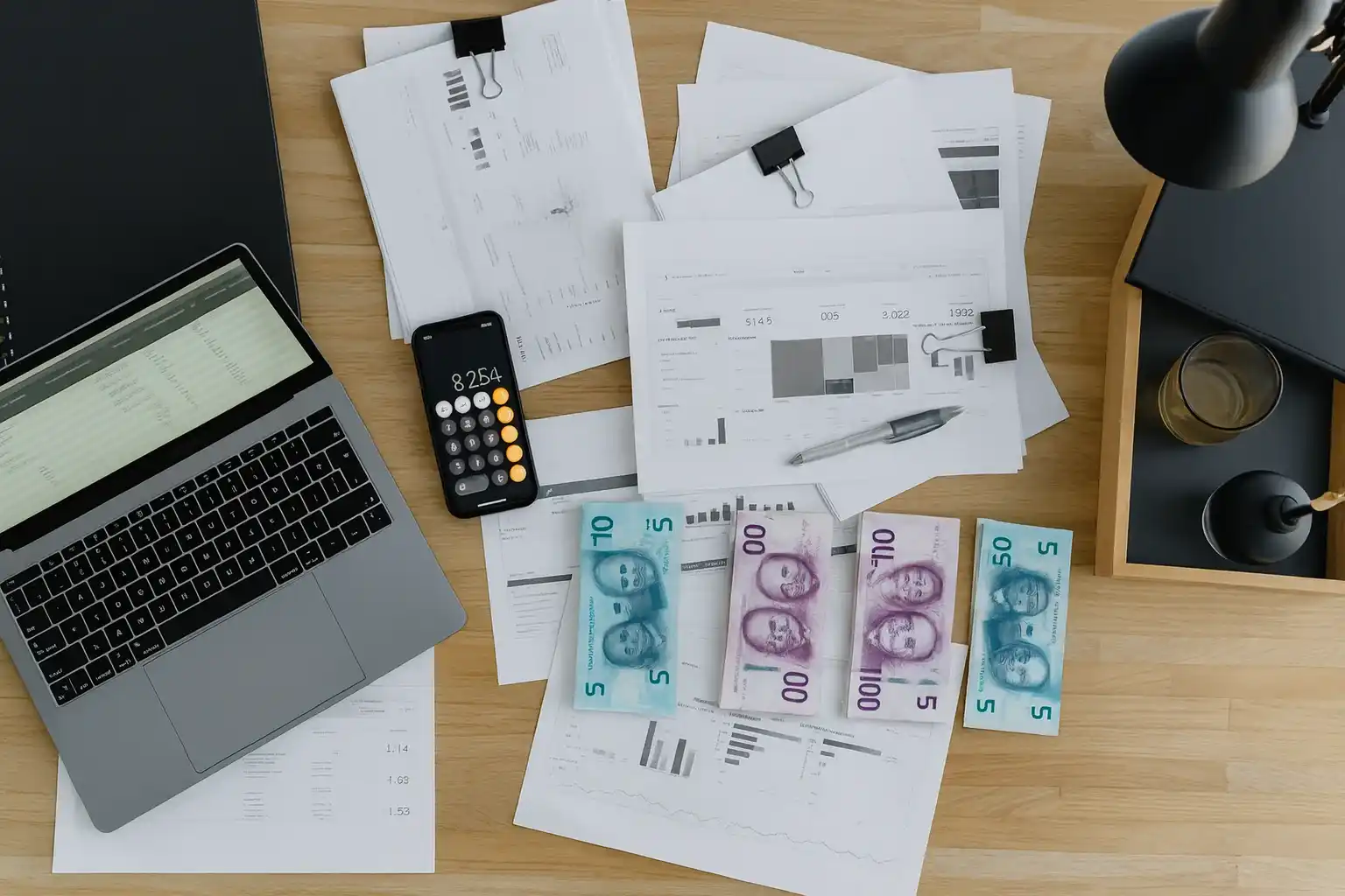 Worker writing on documents at a desk